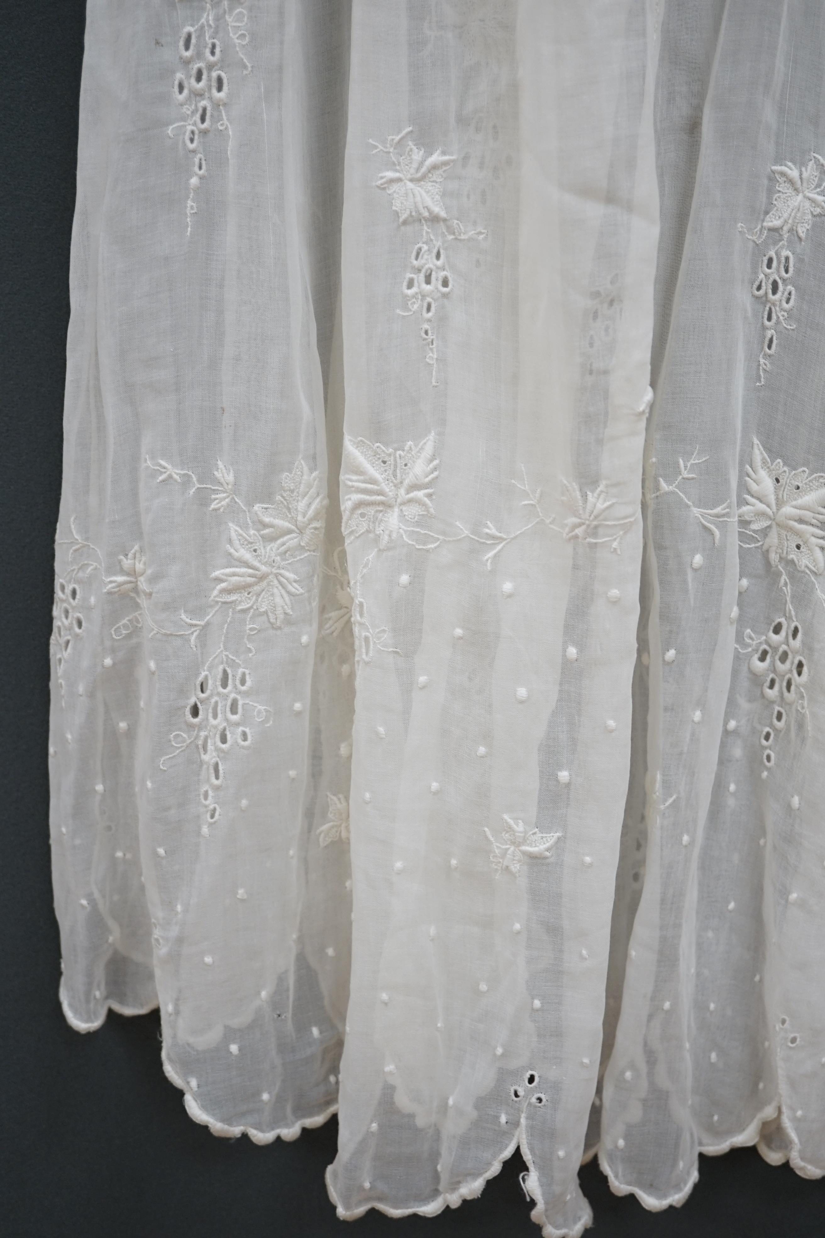 An early Edwardian fine lawn ladies hand made and embroidered crochet dress, embroidered with a white worked skirt, cuffs and lower waist and Irish crochet bodice insertions, with novelty detailing of a faux jacket front